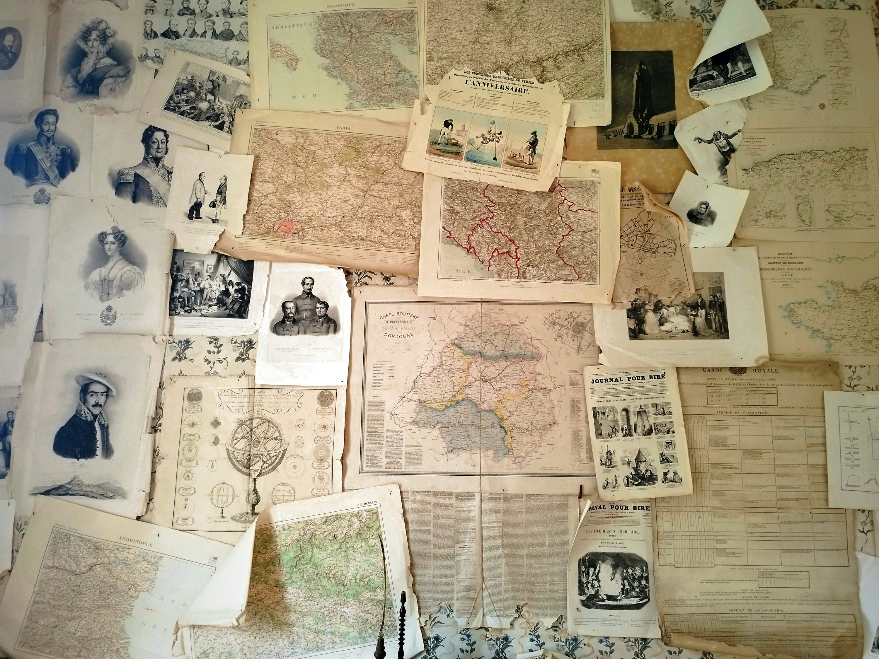 Old maps and family documents spread out for research